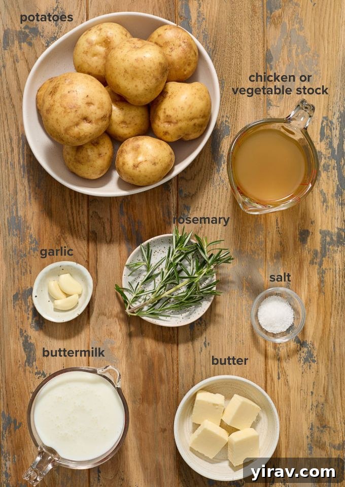 A flat lay of fresh ingredients including potatoes, buttermilk, garlic, rosemary, butter, and chicken stock, ready for the Crock Pot mashed potatoes recipe.