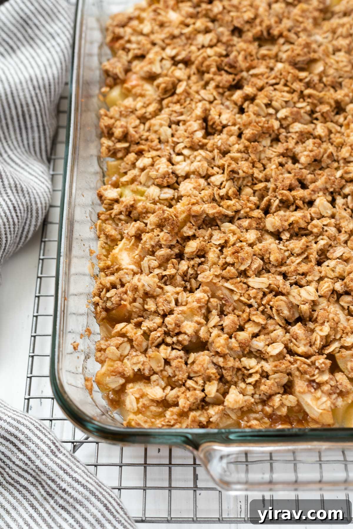 Effortless Apple Crisp 8 A freshly baked apple crisp in a ceramic baking dish, cooling on a wire rack, showcasing its inviting golden-brown crust.