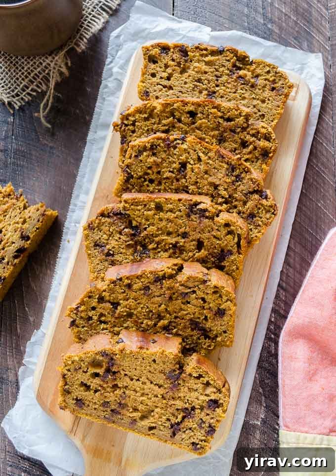 Spiced Pumpkin Chocolate Chip Bread 3 A loaf of Whole Wheat Pumpkin Bread on a cutting board, ready to be sliced.