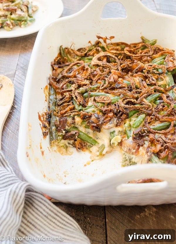 Close up of green bean casserole in baking dish, showing texture of sauce and beans