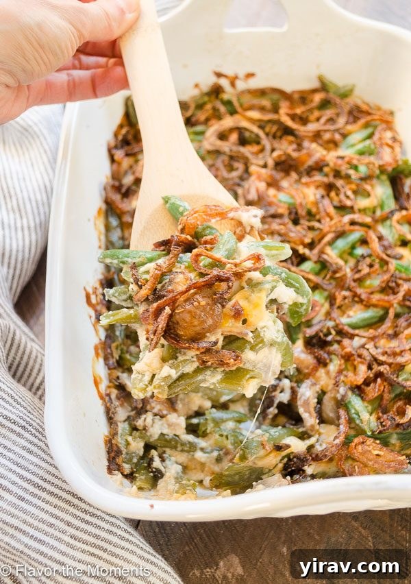 Spoonful of homemade green bean casserole showing creamy sauce and green beans