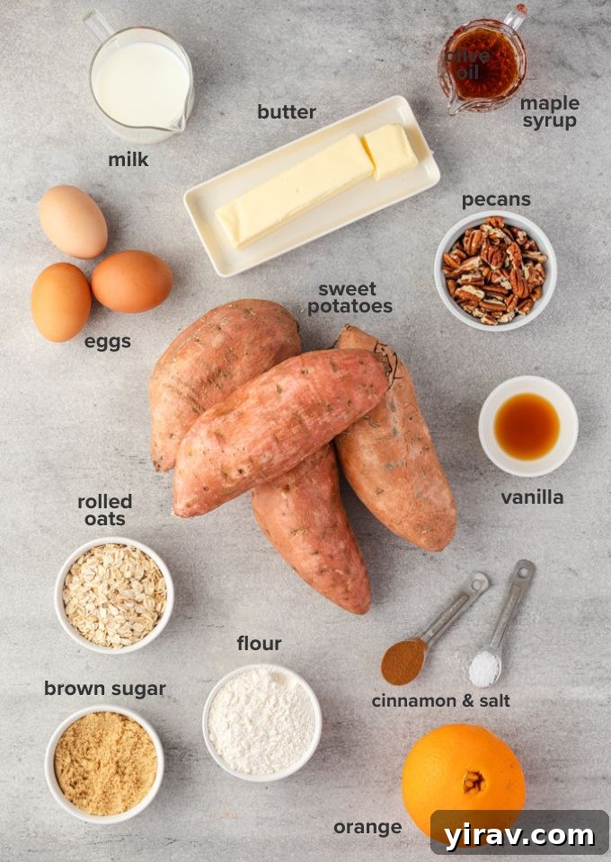 Various sweet potato casserole recipe ingredients laid out on a kitchen counter, including sweet potatoes, eggs, butter, milk, maple syrup, orange, vanilla extract, flour, oats, and pecans