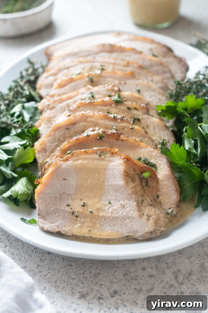 Pork loin roast on a platter smothered in dijon cream sauce