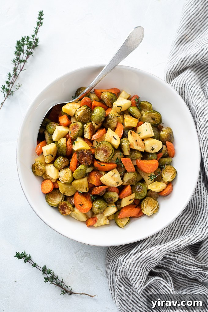 Roasted brussels sprouts and carrots in a bowl with thyme