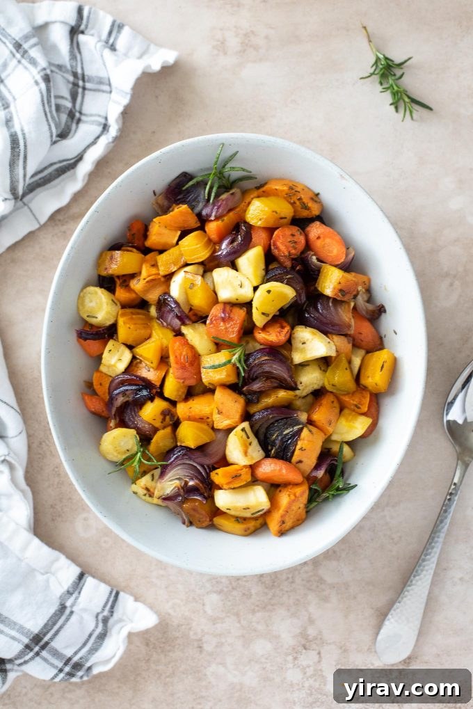 Roasted root vegetables in a white serving bowl