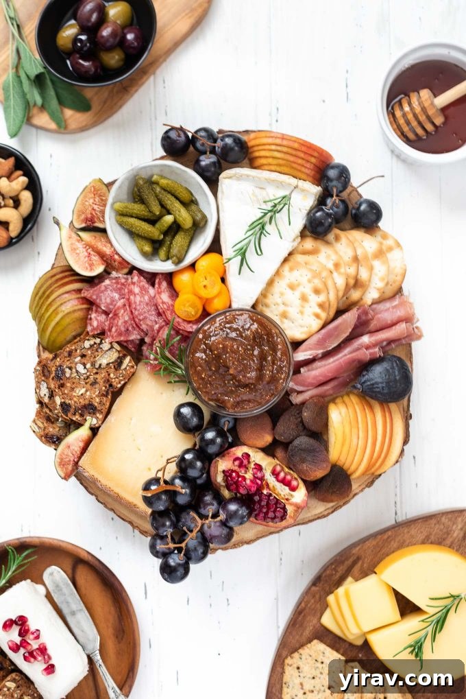 Cheese board filled with a variety of meats, cheeses, fruit and crackers