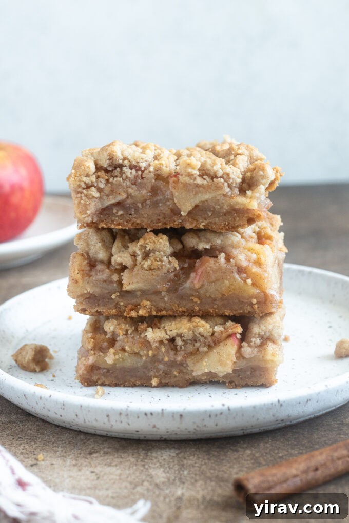 Stack of apple pie bars on a plate.