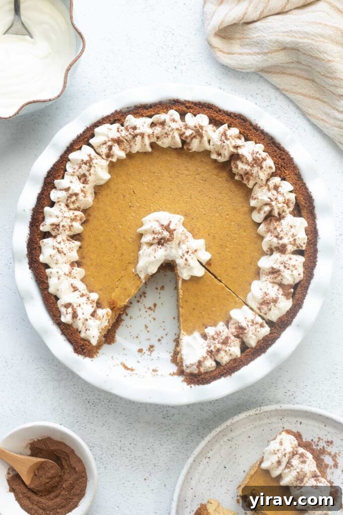 Pumpkin cheesecake pie with a slice cut out.