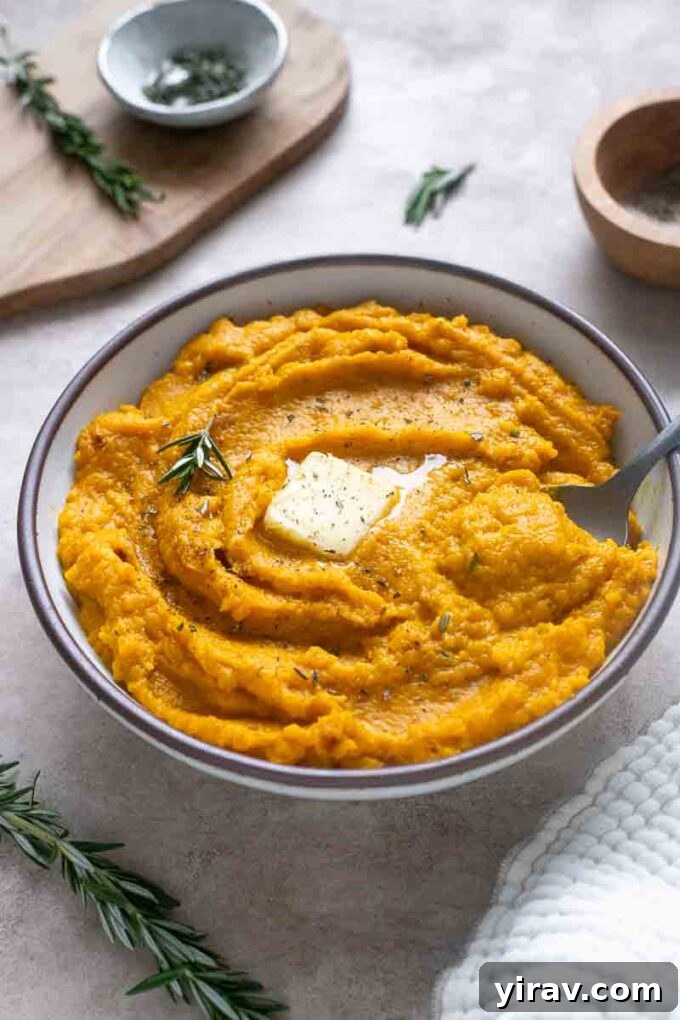 Velvet Kabocha Puree 2 Creamy kabocha squash mash in a serving bowl, garnished with fresh rosemary.