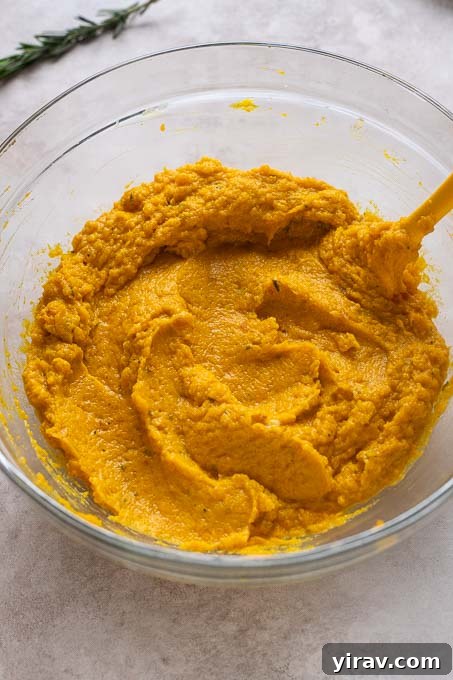 Velvet Kabocha Puree 10 Creamy kabocha mash being mixed in a bowl.