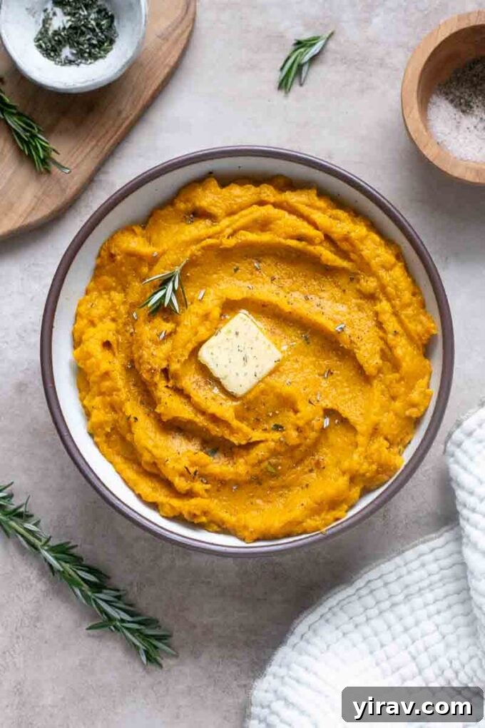Velvet Kabocha Puree 3 Kabocha mash in a serving bowl with a swirl of butter and fresh rosemary garnish.