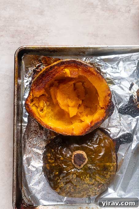 Velvet Kabocha Puree 8 Roasted kabocha squash halves on a baking sheet.