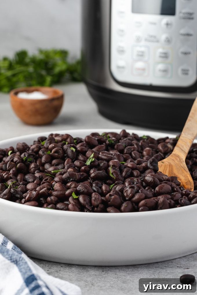 Instant Pot Black Beans: No Soaking Necessary 3 Instant pot black beans in a bowl with instant pot in the background