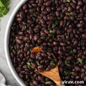 Instant Pot Black Beans: No Soaking Necessary 9 Instant pot black beans in a bowl with a spoon