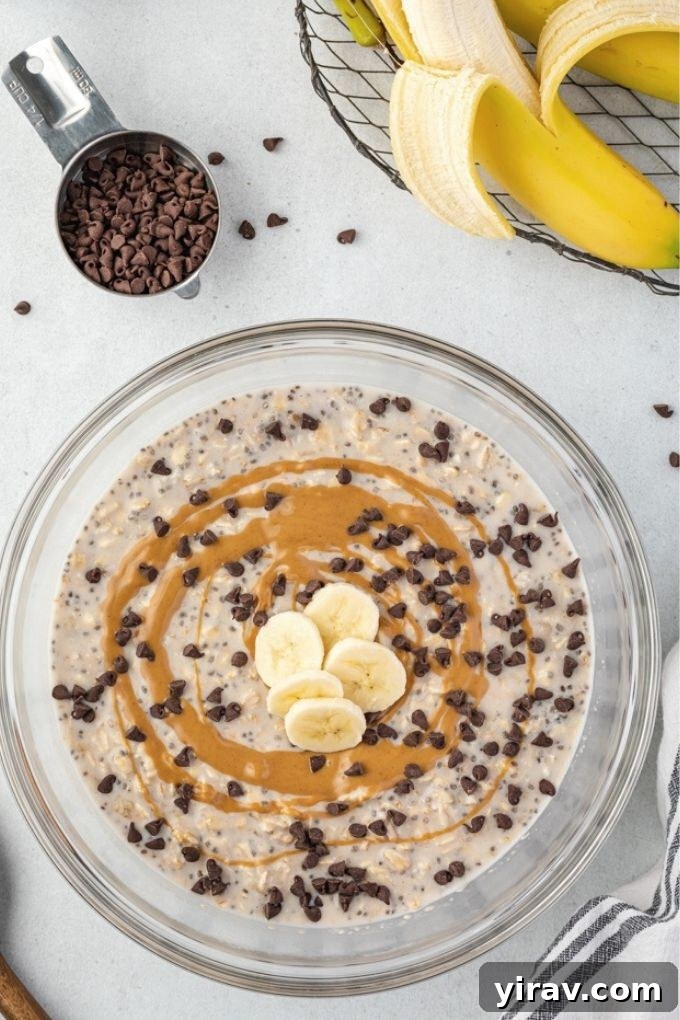 Overnight Peanut Butter Oat Bliss 6 A large mixing bowl filled with peanut butter banana overnight oats, mixed and ready for chilling, showcasing its creamy consistency before refrigeration.