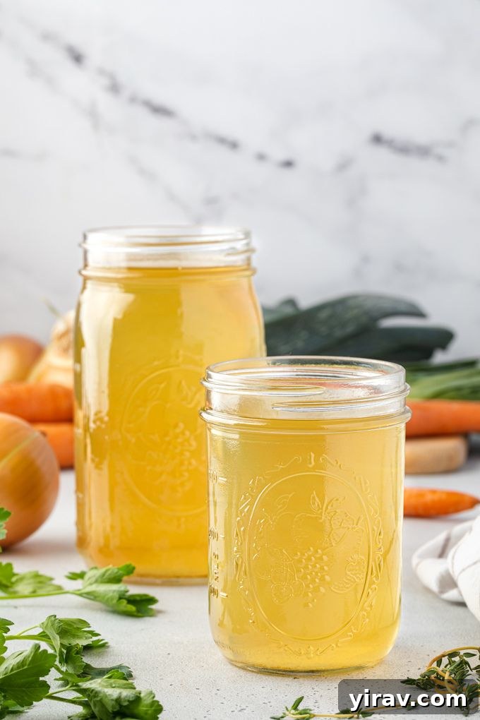 Multiple glass jars filled with homemade vegetable broth, neatly arranged, indicating successful batch preparation and readiness for storage.