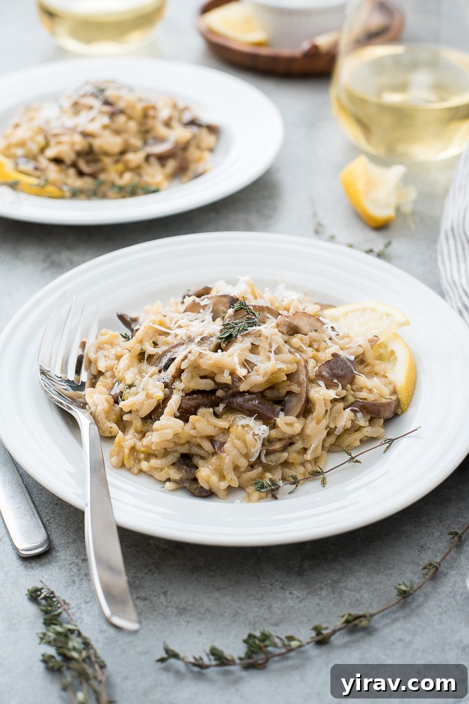 Velvety Instant Pot Mushroom Risotto 3 Plate of Instant Pot Mushroom Risotto with fresh lemon slices and thyme sprigs