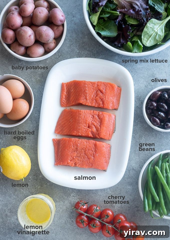 Vibrant Salmon Nicoise 4 Fresh ingredients laid out for Salmon Niçoise Salad, including salmon fillets, potatoes, green beans, eggs, tomatoes, and olives.