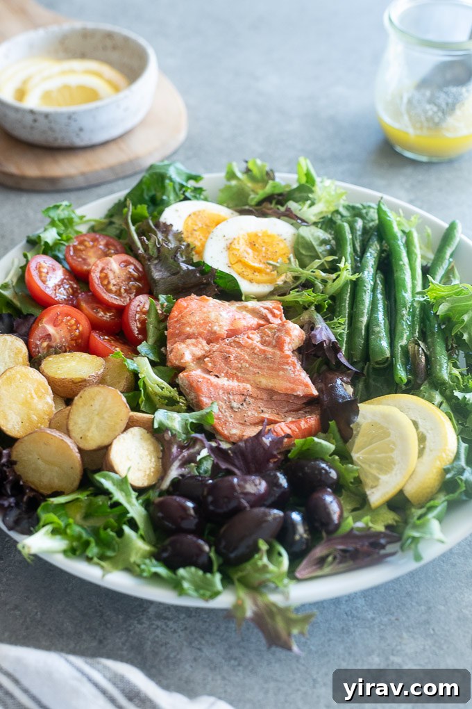 Vibrant Salmon Nicoise 7 A close-up of Salmon Niçoise Salad drizzled with lemon vinaigrette, highlighting the freshness and vibrant colors.