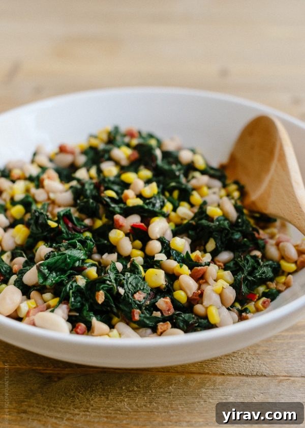 A white bowl showcasing Swiss chard with crispy pancetta, sweet corn, and cannellini beans, creating a rich and flavorful side dish.
