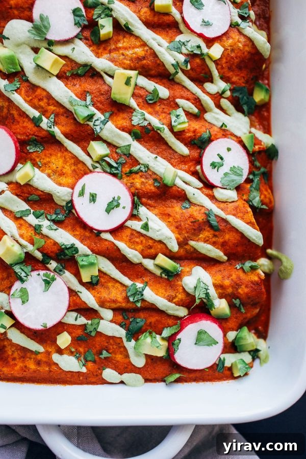 Delectable Swiss chard mushroom enchiladas baked in a dish, showcasing a rich and flavorful vegetarian filling.