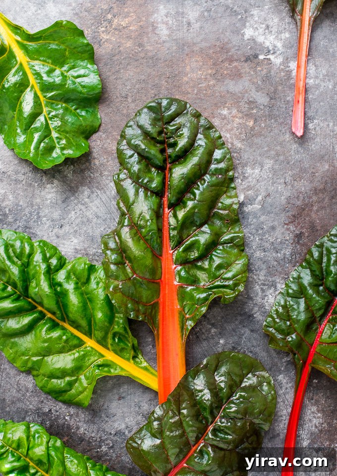 Close-up of fresh rainbow Swiss chard leaves, vibrant and ready for cooking.