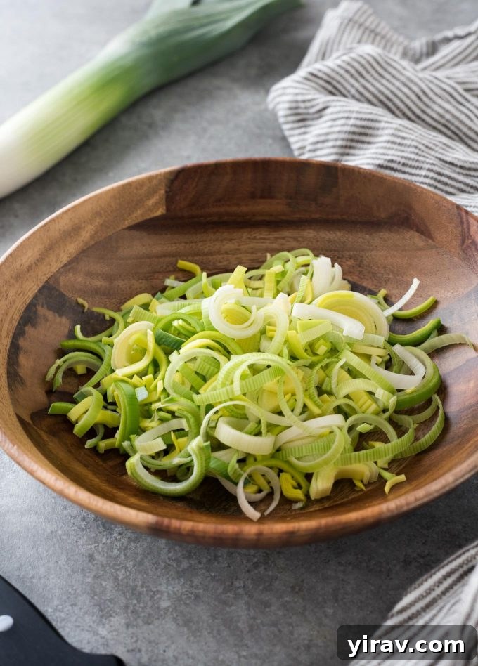 Chopped leeks in a teak bowl