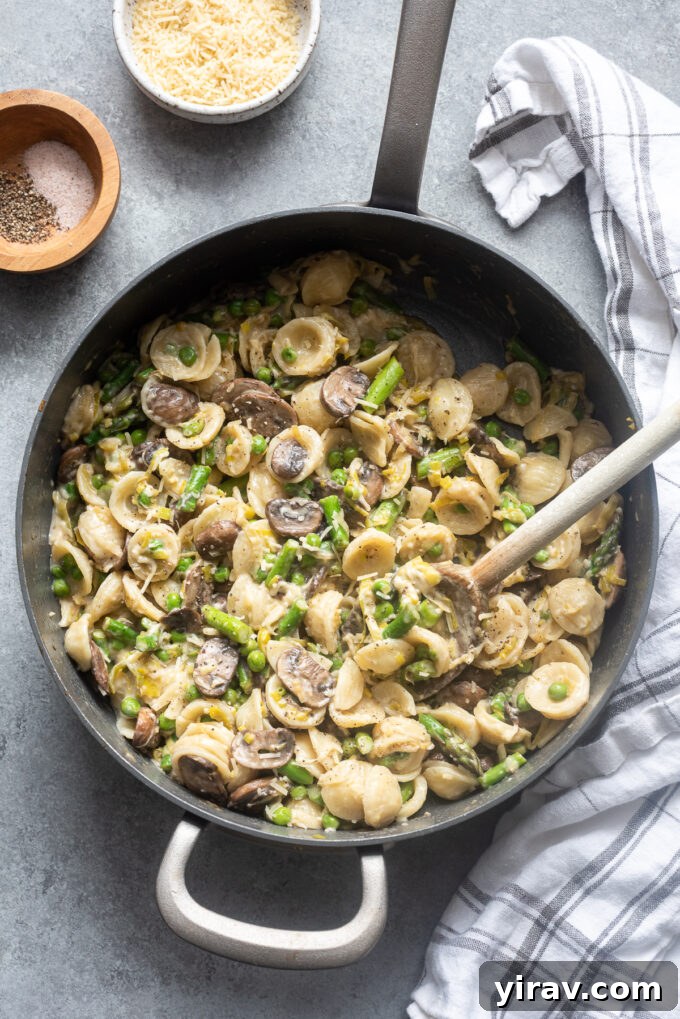 One pot pasta primavera with spring vegetables in skillet.