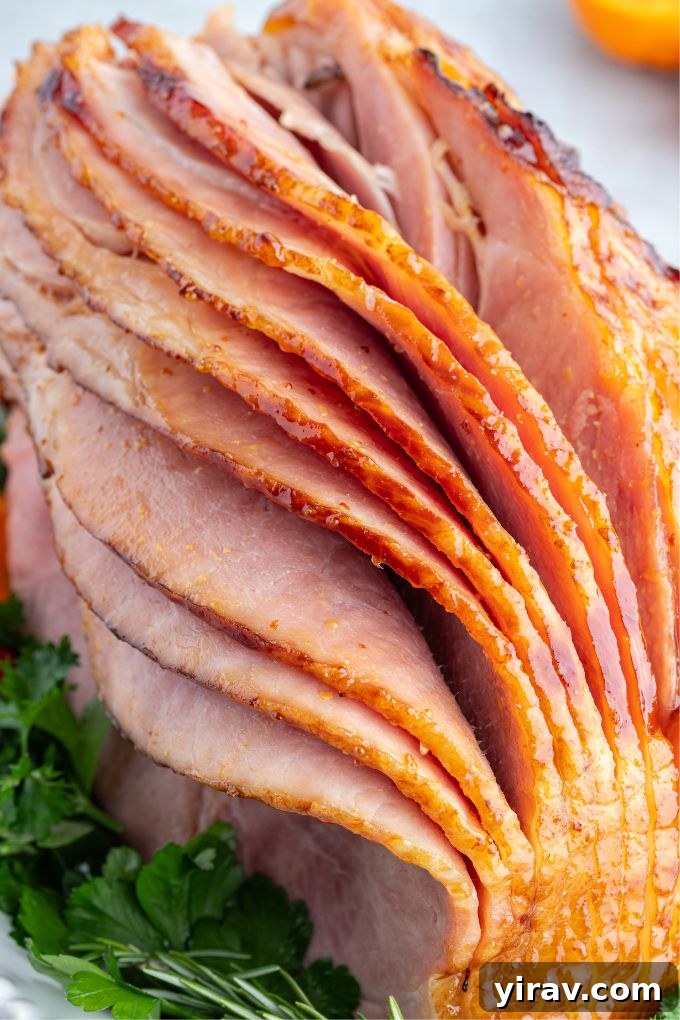 Slow cooker ham with maple glaze on a platter with slices pulled apart