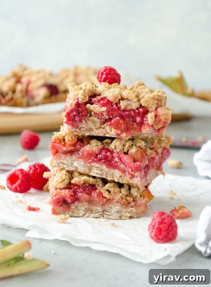 23 Rhubarb Recipes Essential Produce Guide 7 A stack of delicious Raspberry Rhubarb Oatmeal Bars, showcasing their wholesome layers and crumbly topping.