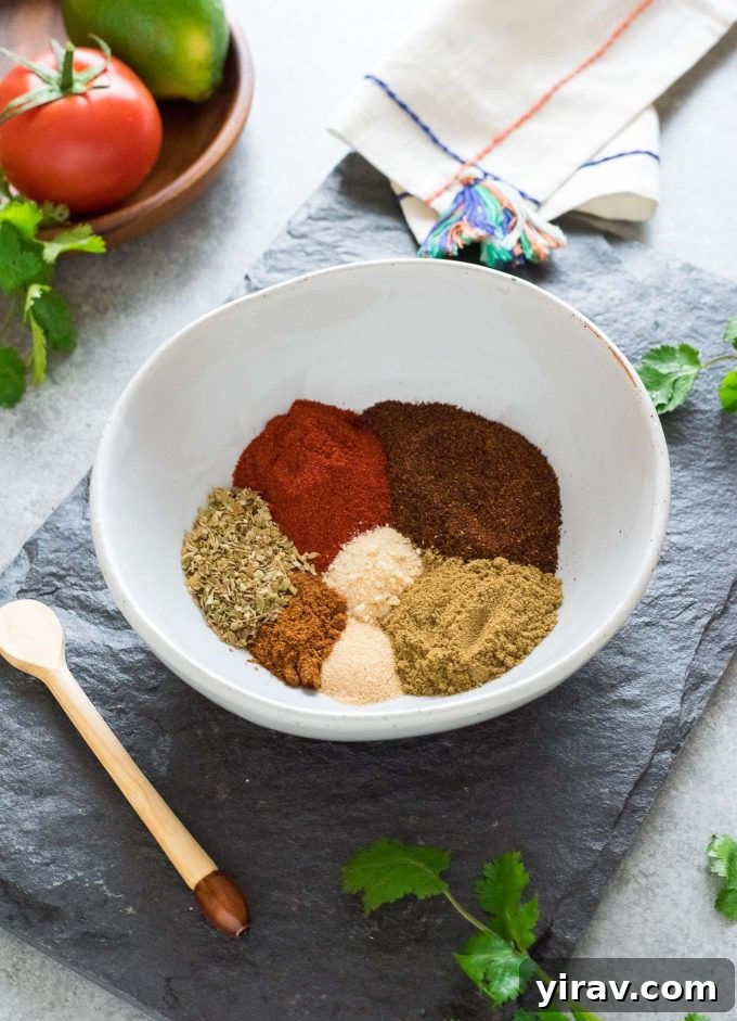 A rustic bowl filled with colorful, freshly mixed homemade taco seasoning, showcasing its rich texture and natural ingredients, ready to be stored or used.