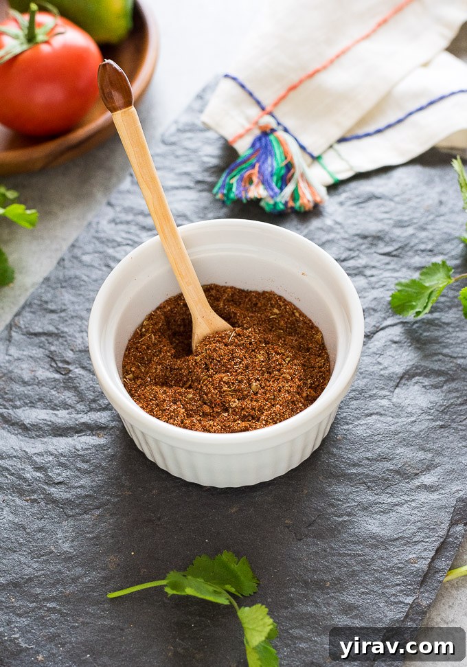 A glass jar filled with freshly made DIY Taco Seasoning, ready for storage and use, highlighting its homemade quality and vibrant color.