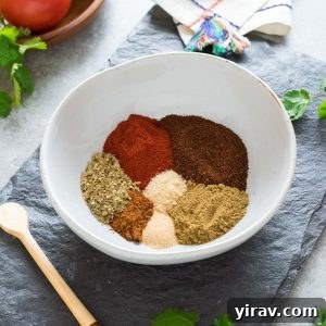 A bowl filled with freshly made homemade taco seasoning, accompanied by a measuring spoon, highlighting the ease and deliciousness of DIY spice blends.