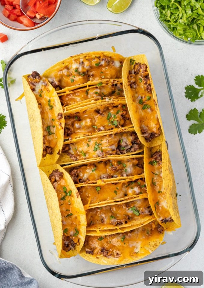 Golden Brown Turkey Tacos 2 Crispy Oven Baked Turkey Tacos filled with seasoned meat, refried beans, and cheese in a baking dish, ready to serve.