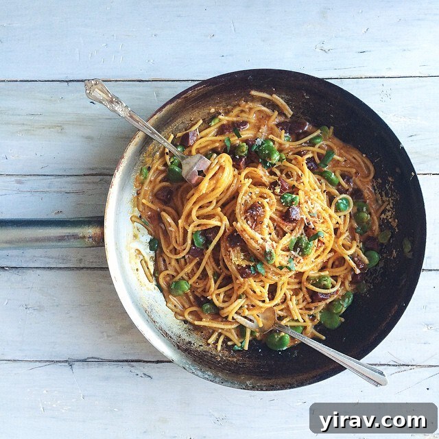 Hearty Chorizo Carbonara pasta dish with vibrant fava beans, offering a flavorful twist on a classic.