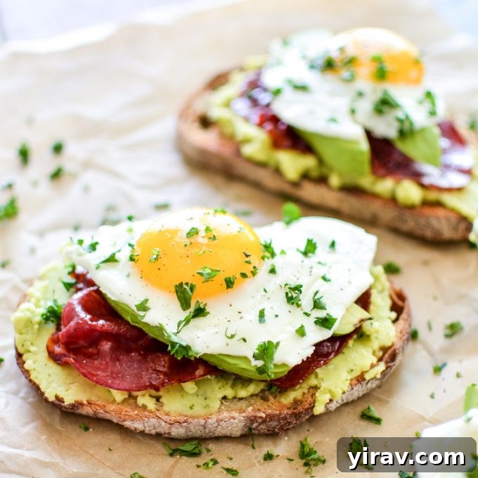 Gourmet Breakfast Toast with creamy fava bean spread and crispy capicola, served on parchment paper.