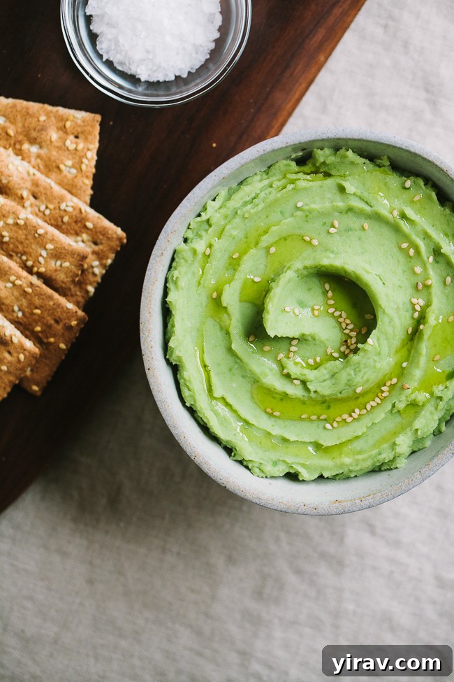 Smooth Fava Bean Puree served in a bowl, garnished with sesame seeds, ideal for toast or as a side.