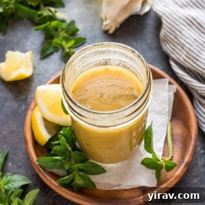 Greek dressing in mason jar with oregano and lemon