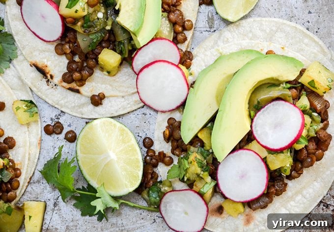 Overhead view of two lentil tacos with pinepple-tomatillo salsa.