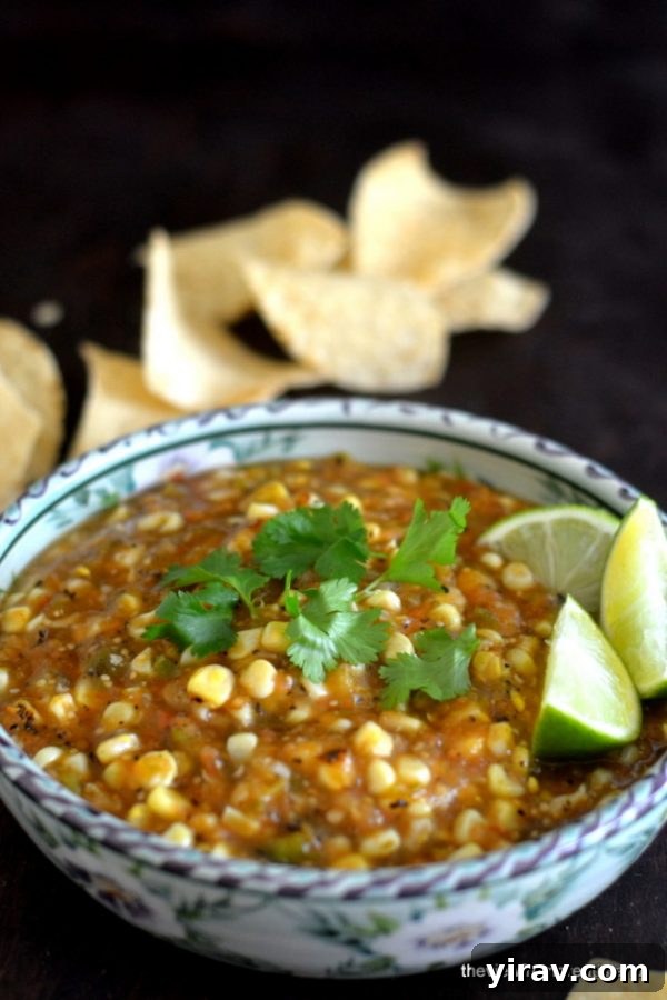 Tomatillo corn salsa in blue and white bowl with chips