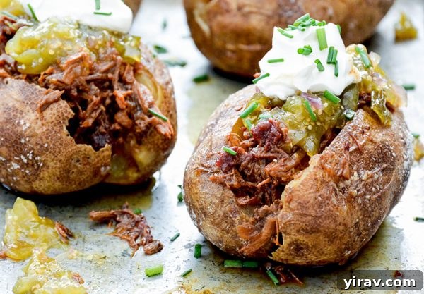 BBQ beef stuffed potatoes with sour cream and tomatillo salsa on top