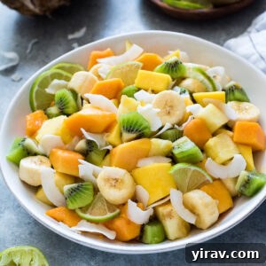 Tropical fruit salad with coconut in a serving bowl.