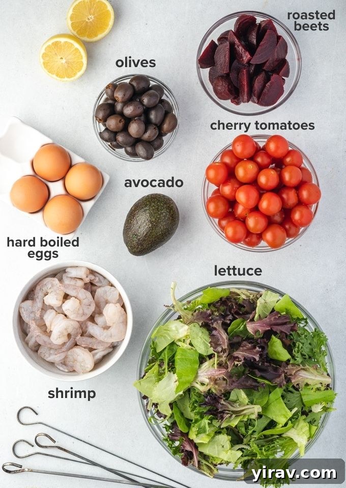 Individual ingredients laid out for a Grilled Shrimp Louie salad, including shrimp, eggs, beets, and vegetables.