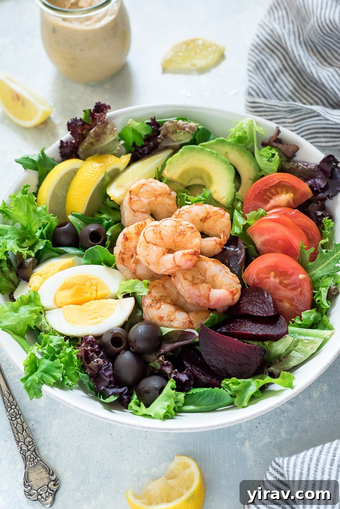 Grilled Shrimp Louie salad served with the homemade Louie dressing in a small jar.