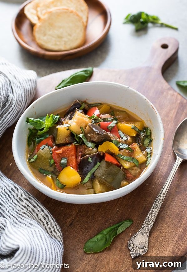 Effortless Instant Pot Ratatouille 5 A beautifully presented bowl of Instant Pot Ratatouille, garnished generously with fresh basil leaves.