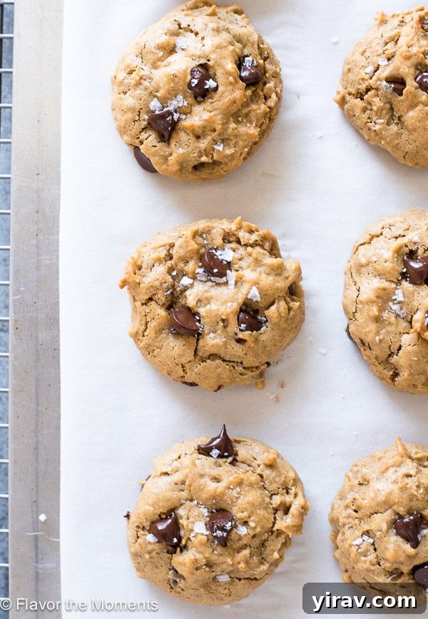 Flourless peanut butter cookies cooling on a baking sheet lined with parchment paper