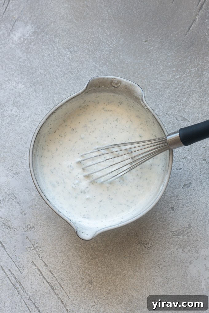 Ingredients for ranch dressing using Greek yogurt combined in a bowl.
