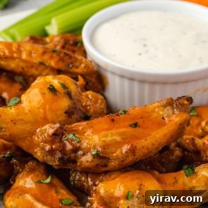 Instant pot chicken wings piled on a plate with ranch dip