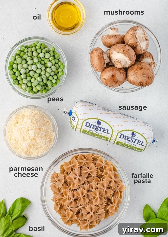 A flat lay photograph showcasing the 7 essential ingredients for the Italian Sausage Bow Tie Pasta: olive oil, Italian sausage, sliced cremini mushrooms, bow tie pasta, frozen peas, Parmesan cheese, and fresh basil.