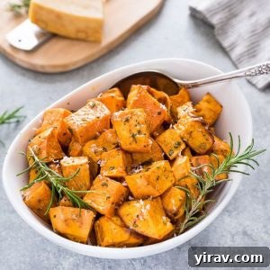 Roasted sweet potatoes in a white bowl with rosemary